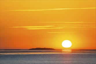 Picturesque, golden, magnificently beautiful sunset over the sea, Langlütjen II island far away,