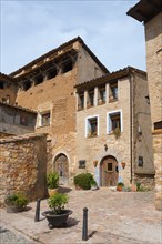 A small, cosy square with historic stone houses and traditional architecture, Alquézar, Alquezar,