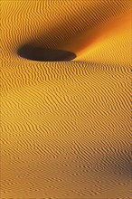 Wind-sculpted sand structure in the Rub al Khali desert, Dhofar province, Arabian Peninsula,