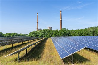 Solar modules of a solar park in front of the decommissioned Plessa lignite-fired power plant with