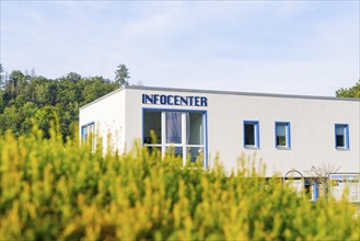 Modern information centre building with large glass windows, surrounded by green nature, Harz