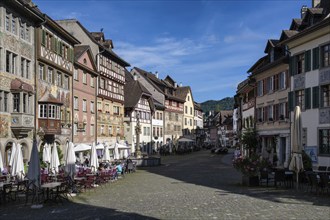 Imposing, historic half-timbered buildings with detailed facade paintings on the market square with