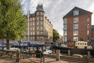 Man sitting on a bench, Wilders Canal, Copenhagen, Denmark, Europe