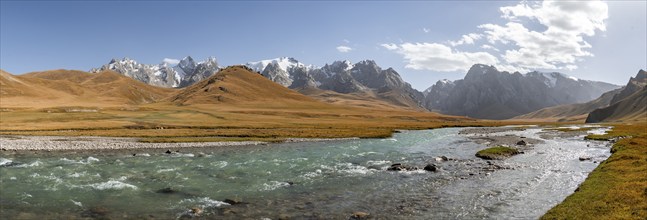 River in front of mountain landscape with yellow meadows, Kol Suu River and mountain peaks, Keltan