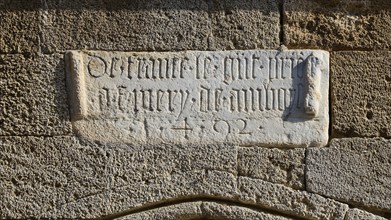 Stone slab with an engraved inscription on an old, historic wall, Knights' Street, Rhodes Old Town,