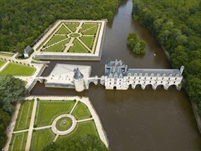 Aerial view of a French castle on the river Cher with neighbouring geometric castle park and green