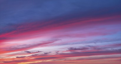 Red glowing clouds in the evening light at sunset, sunset, panorama, wallpaper, sky replacement