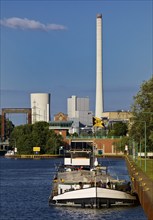 Barge on the Rhine-Herne Canal at the Wanne-Eickel lock with the STEAG power plant in Baukau,