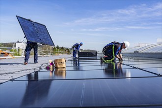 Installation of solar modules on the roof of a commercial enterprise, over 400 photovoltaic modules