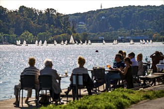 Lake Baldeney in Essen, Ruhr reservoir, sailing boats, café terrace on the shore, Essen, North