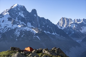 Red tent in front of a mountain panorama, mountain landscape in the morning light, mountain peaks