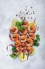 Fried shrimp, without a head, on skewers, shrimp kebabs, with spices, grilled, homemade, without