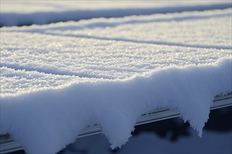 Close up of photovoltaic solar cells on roof of house covered in snow. Generative AI, AI generated