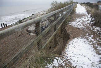 Storm damage to coastal path and crumbling cliff face at East Lane, Bawdsey, Suffolk, England,