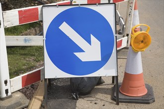 Blue direction arrow road sign at roadworks, Suffolk, England, United Kingdom, Europe