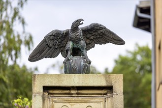 Eagle with globe, sculpture, artwork at a courtyard entrance in Stuttgart, Baden-Württemberg,