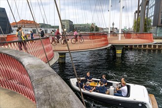 Cyclists on the Cirkelbroen cycle and pedestrian bridge, over the harbour, in the Christianshavens