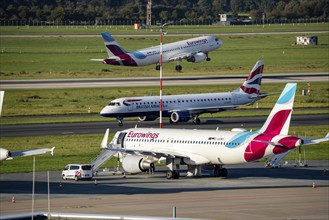 Düsseldorf Airport, Eurowings aircraft on take-off, British Airways aircraft on the taxiway and in