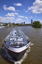 Tanker Erik Walther on the river Main under a blue sky with cumulus clouds in Frankfurt am Main,