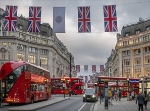 Red double-decker buses, English flags, evening mood, Oxford Circus, London, London region,