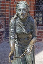 Grete-Minde monument in front of the historic town hall in the old town centre of Tangermünde. The