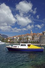 Crystal clear water, leisure boat and the old town centre of Korcula, Adriatic Sea, Mediterranean,