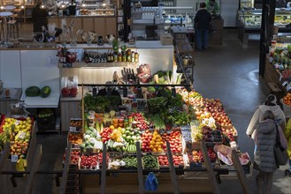 Fruit and vegetable stall with Cucumbers, tomatoes, melons, Leeks, Malus and spices, Riga, Latvia,