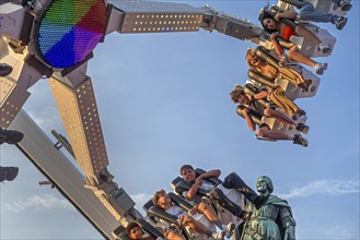 Thrillseekers having fun on fairground attraction during the Gentse Feesten, Ghent city festival,