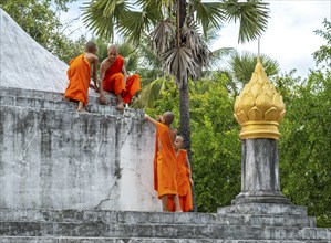 Monks cleaning the Wat Wisunarat temple, Luang Prabang, Laos, Asia