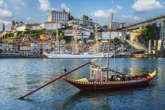 View of Porto city and Douro river with traditional boats with port wine barrels and sailing ship