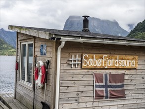 Floating sauna, marina of village Saebo at the Hjørundfjord, Norway, Europe