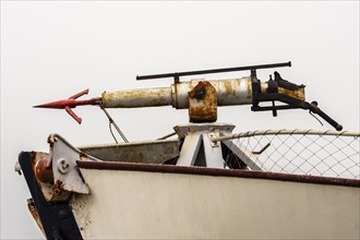 Gun with harpoon on former whale hunting boat converted to a restaurant, Tranoya, northern Norway