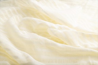 Fragment of white linen tissue. Side view, natural textile background and texture. wave concept,