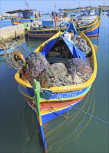 Colourful traditional fishing boats called luzzu in the harbour at Marsaxlokk, Malta, Europe