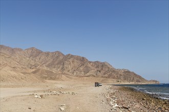 The coastline of the Red Sea and the mountains in the background. Egypt, the Sinai Peninsula, Dahab