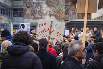 Demonstrators with signs on which socially critical slogans can be read, demonstration against the