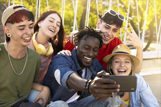 Multi-ethnic boys and girls taking selfie outdoors. A group of young people capturing a happy