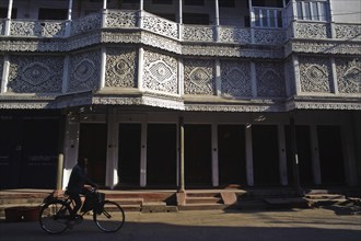 Cyclist in front of a ornate house, street scene at Daltonganj, Jharkhand, India, Asia