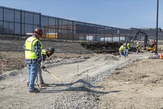 Detroit, Michigan, Workers build walkways on a section of the Joe Louis Greenway. When complete,