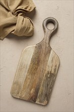 Cutting board, wooden, rectangular shape, with handle, with kitchen towel, top view, no people