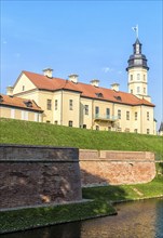 Ancient restored castle with a moat in the Nesvizh city. Belarus