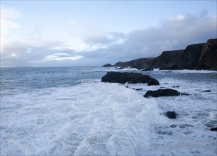 Large Atlantic storm waves crashing onto jagged rocky coast at Hartland Quay, north Devon, England,