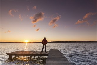 Man on jetty at Lake Ratzeburg, Ratzeburger See at Lauenburg Lakes Nature Park, Naturpark