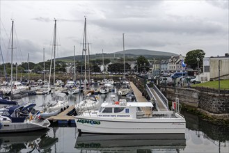 Harbour with many boats and a cloudy mountain in the background, Ballycastle