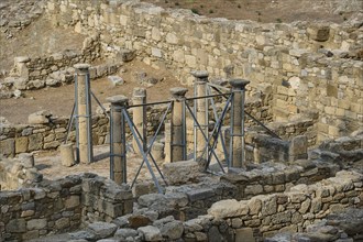 Archaeological site with ruins and stone columns in the open air, Atrium house, Kamiros,