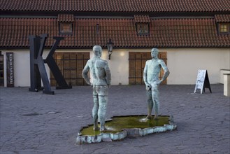 Two male figures peeing, sculpture by the artist David Cerny in front of the Franz Kafka Museum,