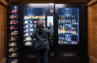 Elderly woman buying groceries at vending machine, display, food vending machine, farm shop,