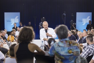 Olaf Scholz (Chancellor of the Federal Republic of Germany, SPD) surrounded by guests at the