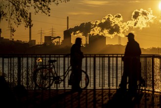 Rhine promenade in Duisburg-Wanheim, sunset, view of the Rhine and Hüttenwerke Krupp Mannesmann,