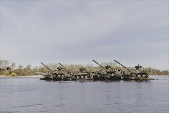 Four Pandur II tanks cross the Elbe with the Bundeswehr's Amphibie M3 floating high-speed bridge as